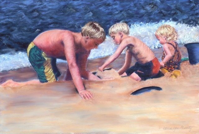 Three-kids-making-a-sand-castle